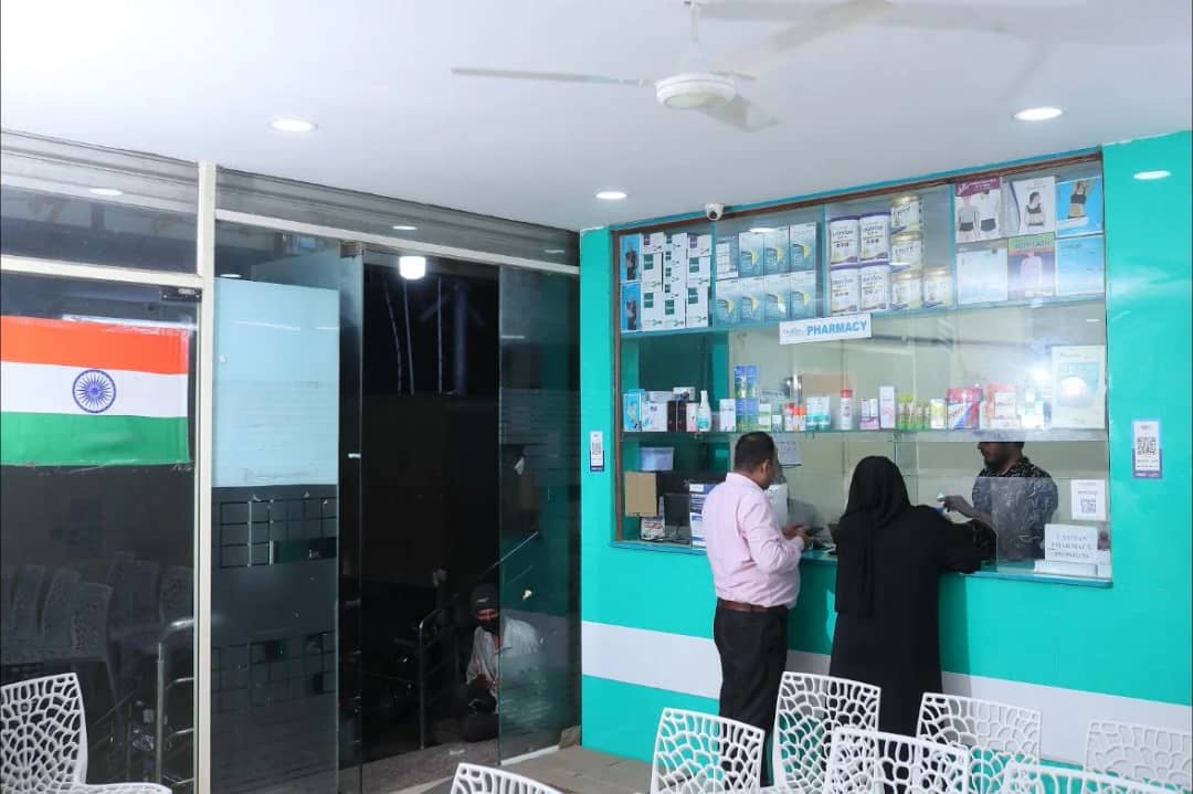 The 24-hour pharmacy counter at Caspian Healthcare, with the waiting chairs beside it