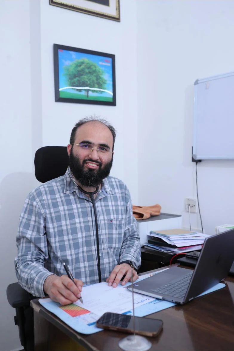 Dr. Khizer Hussain Junaidy at his consulting desk at Caspian Healthcare, Hyderabad