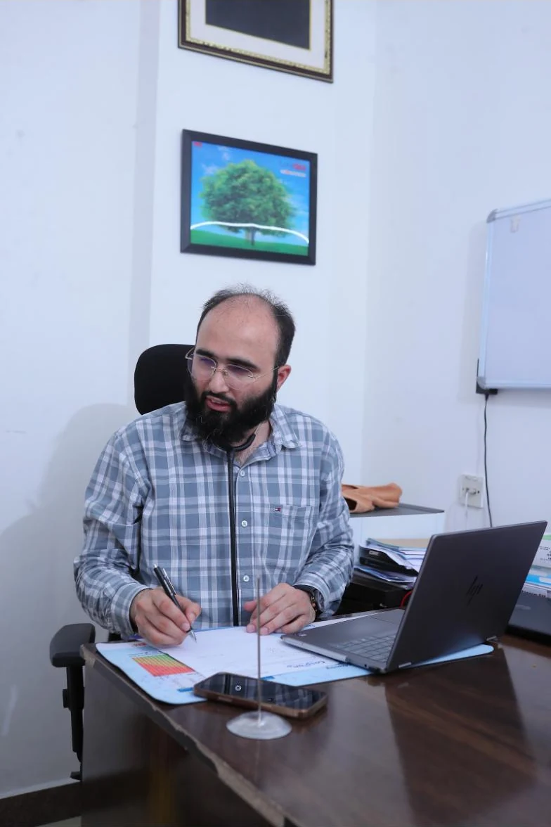 Dr. Khizer Hussain Junaidy at his desk at Caspian Healthcare, Vijay Nagar Colony