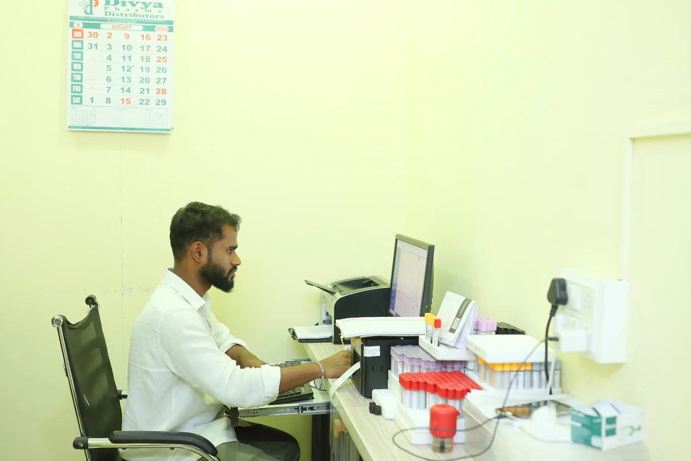 A laboratory technician registering samples at the bench at Caspian Diagnostic Centre, Vijay Nagar Colony, Hyderabad