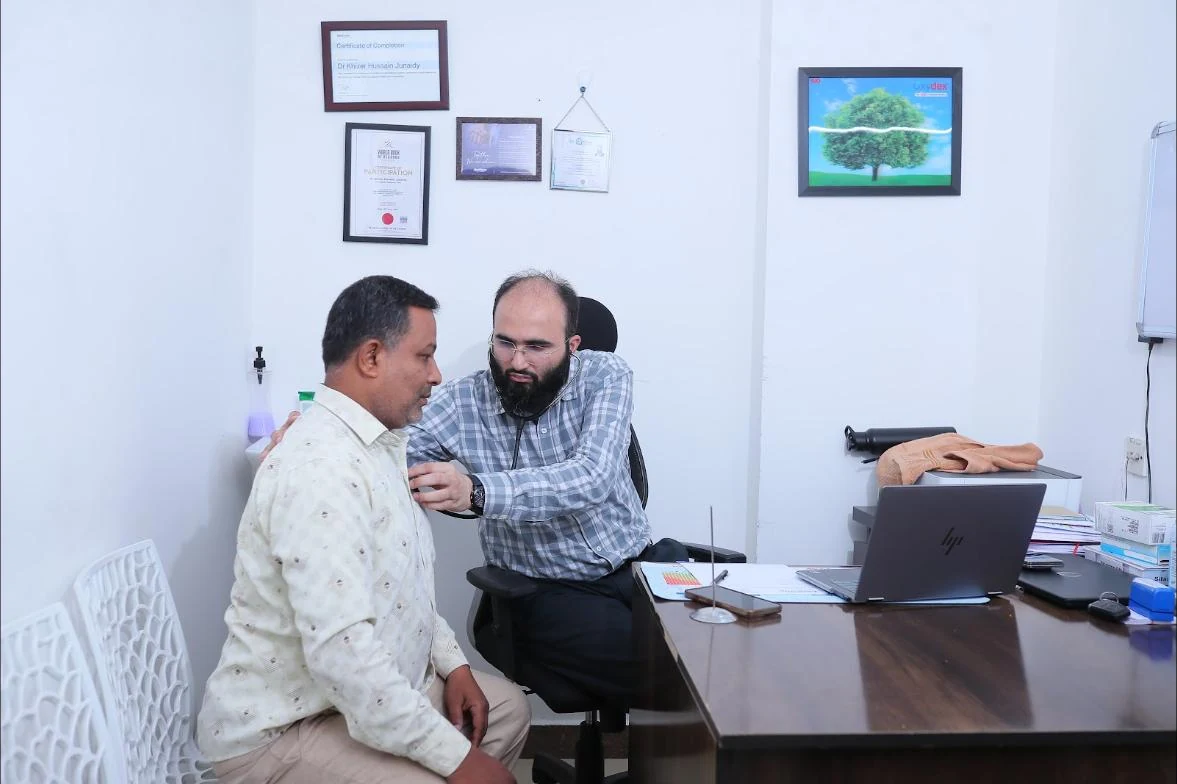 Dr. Khizer Hussain Junaidy examining a patient at Caspian Healthcare