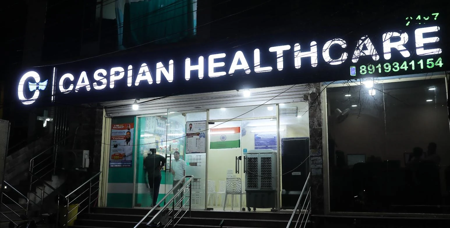 Caspian Healthcare on its street in Vijay Nagar Colony, Hyderabad, at night with the sign lit