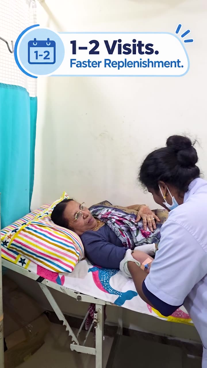 A nurse at Caspian Healthcare setting up an intravenous iron infusion for a patient resting on a day care bed